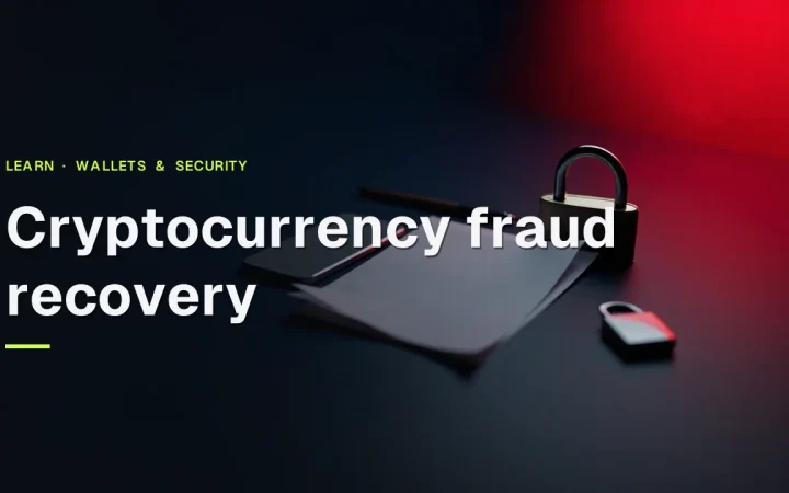 Cryptocurrency fraud recovery title over a dark navy desk with a blank phone, padlock, blank papers and a pen lit by red light