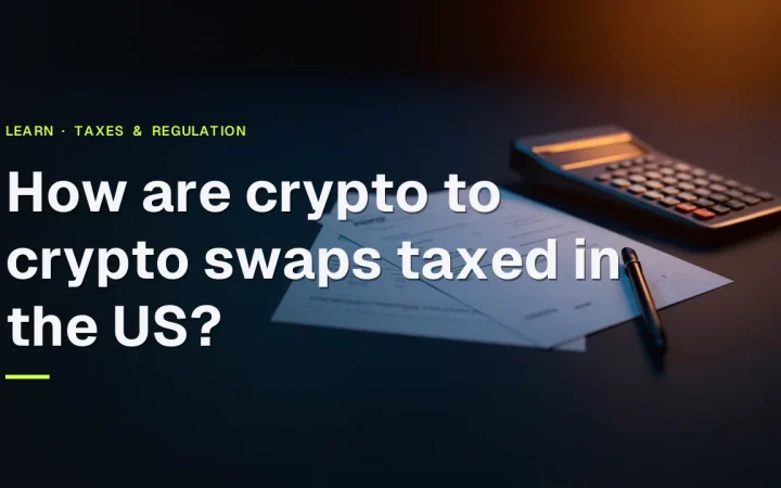The title How are crypto to crypto swaps taxed in the US? over a dark desk with blank tax forms, a calculator and a pen.