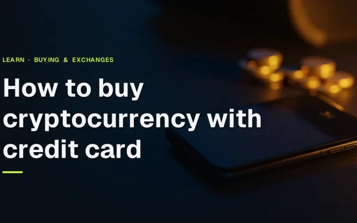 How to buy cryptocurrency with credit card in gold text over a dark desk with a credit card, phone and coins.