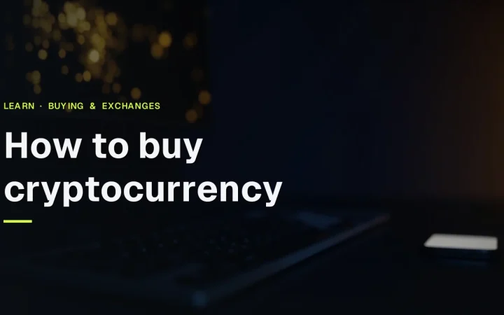 The guide title How to Buy Cryptocurrency over a dark desk with a keyboard, a monitor of glowing gold bars and a phone.