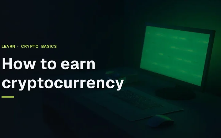 The title How to Earn Cryptocurrency over a dark desk with a glowing monitor and blank keyboard.
