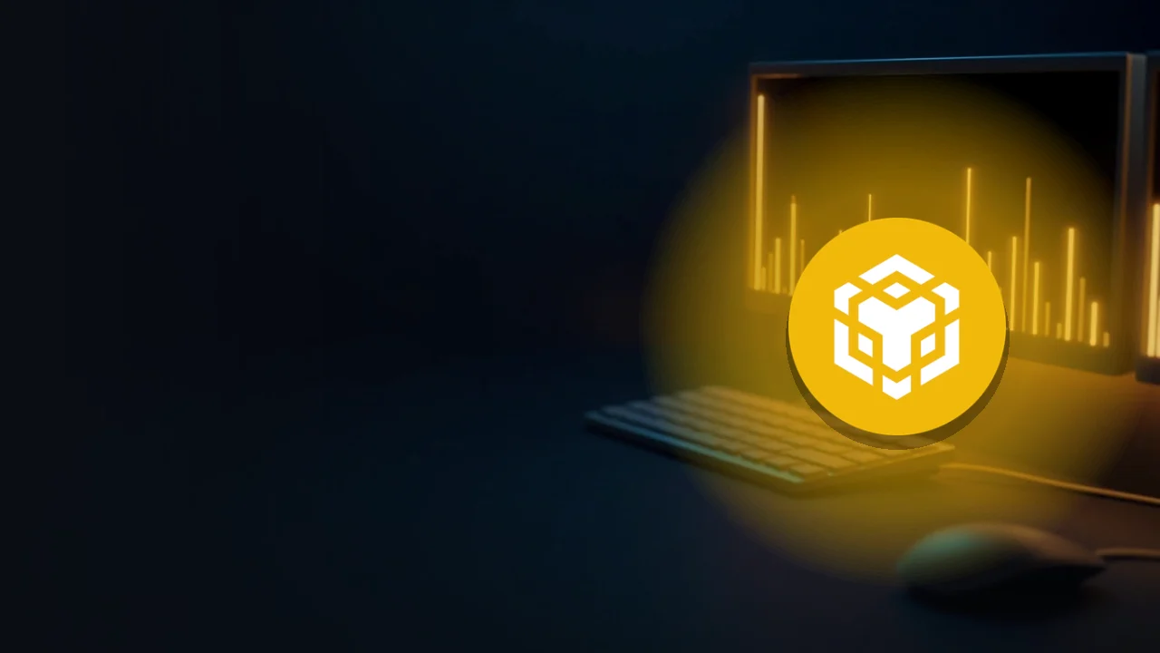 BNB-logoet over glødende guld-bar-charts på et mørkt skrivebord.