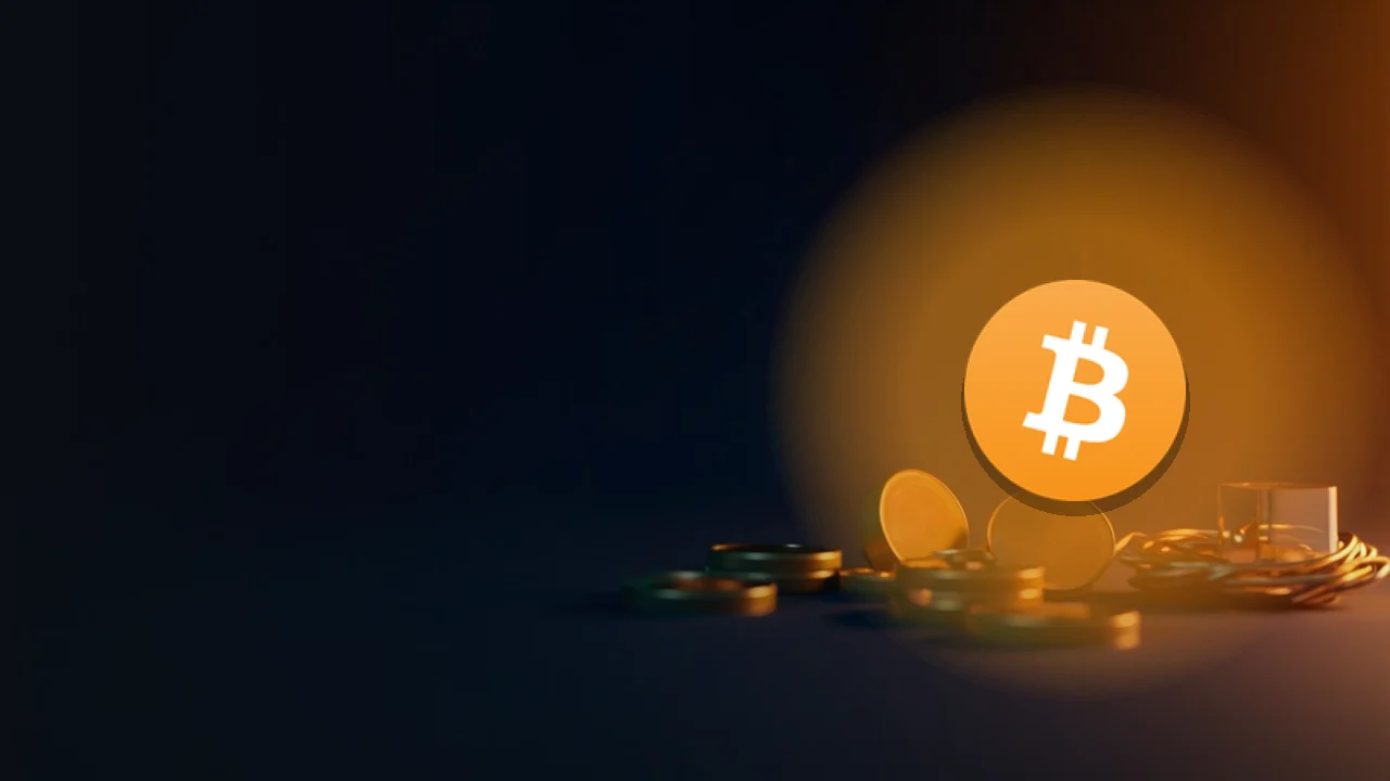 El logotipo de Bitcoin sobre un fondo azul marino oscuro con discos de latón, un cubo de cristal y cable de cobre a la derecha.