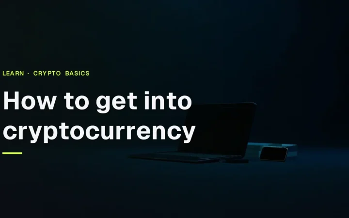The title How to get into cryptocurrency over a dark desk with a laptop, phone and blank cards, lit by a lime green glow.