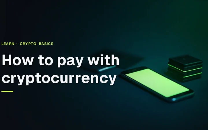 A dark desk with a glowing phone, a hardware wallet and blank payment cards, under the title How to pay with cryptocurrency.