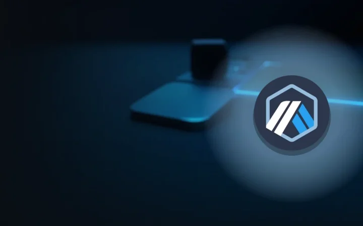 The Arbitrum logo over a dark navy background with a glass block, a blank steel plate and a small device lit in cyan.