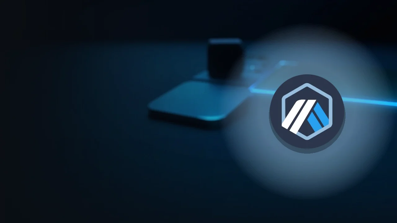 The Arbitrum logo over a dark navy background with a glass block, a blank steel plate and a small device lit in cyan.