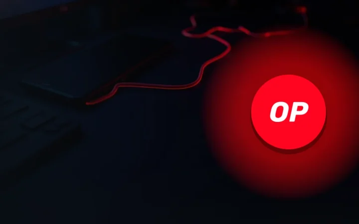 The Optimism logo over a dark desk with a glowing red cable.