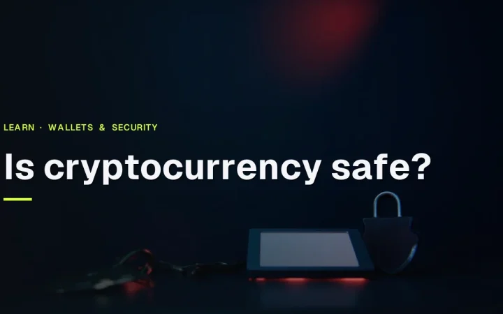 The title Is cryptocurrency safe? over a dark navy scene with a hardware wallet, steel plate, padlock and shield lit in red.