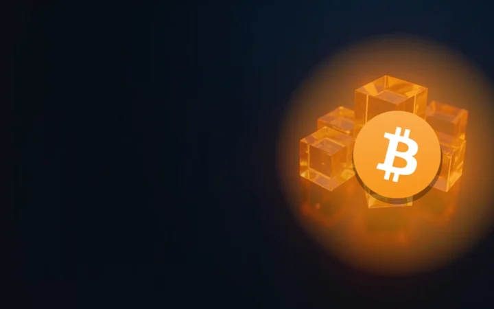 The Bitcoin logo over a glowing orange glass cube joined by light to smaller blank cubes on a dark navy background.