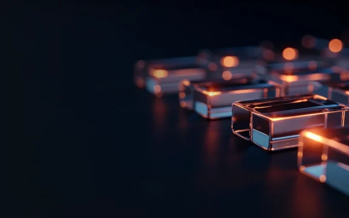 Glowing glass blocks joined by light on a dark navy background.