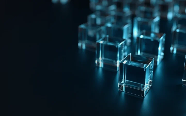Des blocs de verre sombre reliés par une lumière cyan sur un fond bleu marine foncé.