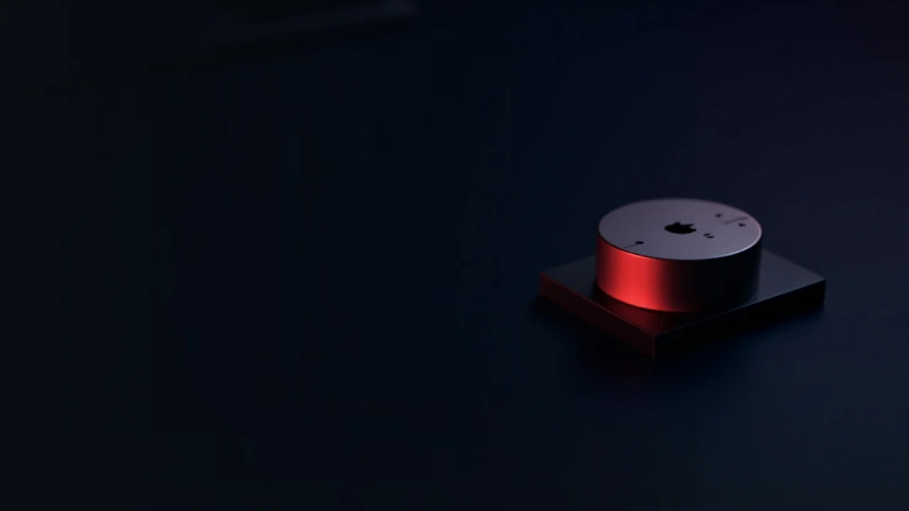 A dark desk with a hardware wallet and steel plate lit by red glow.