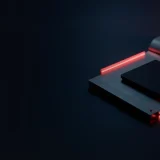 A hardware wallet with a blank screen, a steel plate and a padlock glow red on a dark navy background.