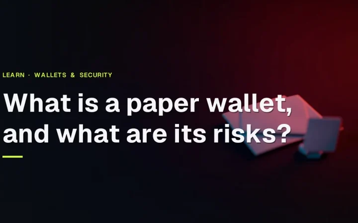 The title What is a paper wallet and what are its risks over a dark desk with blank paper and a key card lit in red.