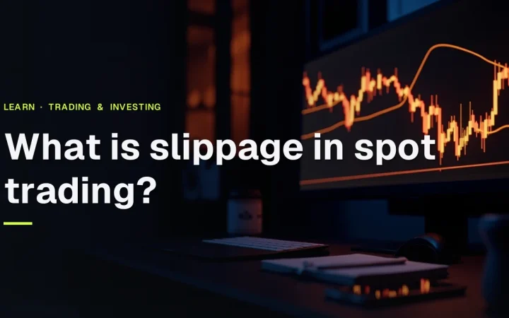 What is slippage in spot trading? title over a dark trading desk with a monitor showing abstract orange price bars.