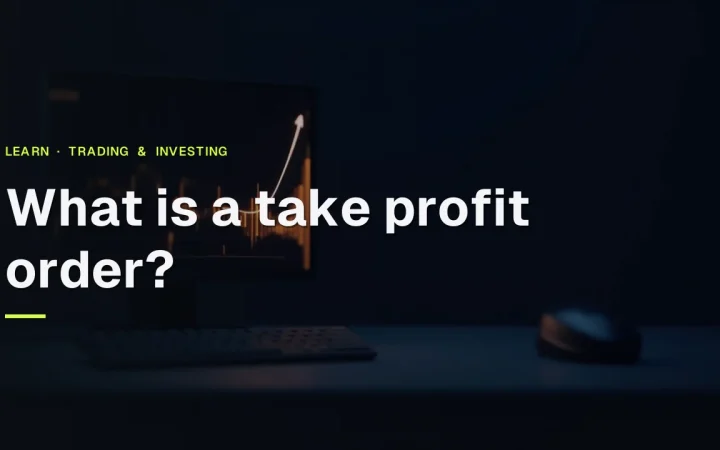 The title What is a take profit order? over a dark desk with a monitor showing glowing orange bars and an upward arrow.