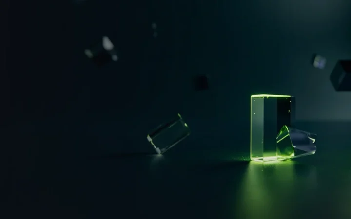 A dark navy background with glowing lime green glass blocks joined by light on the right.
