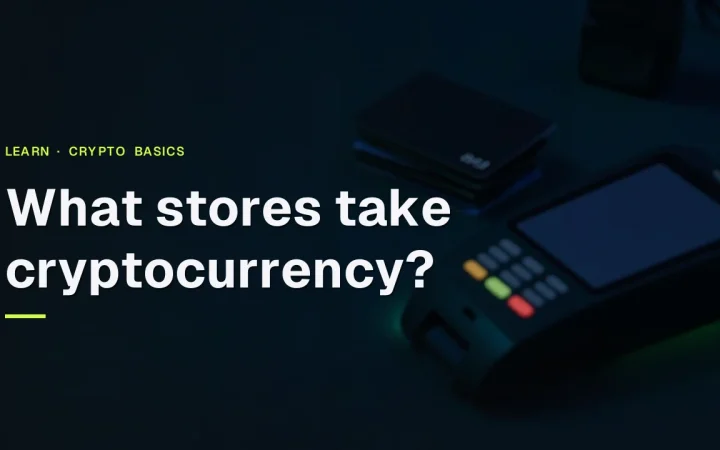 A dark desk with a card terminal, blank cards and a lockbox under lime green light, with the title What stores take cryptocurrency?
