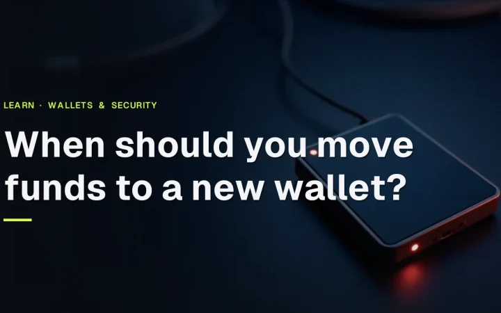 Hvornår bør du flytte midler til en ny wallet? En hardware wallet med tom skærm og en stålplade på et mørkt navy skrivebord.